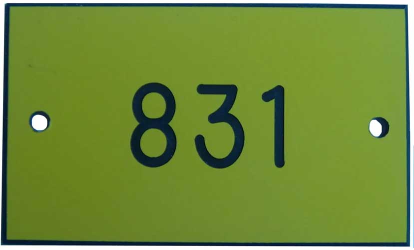 engraved yellow tag with black letters
