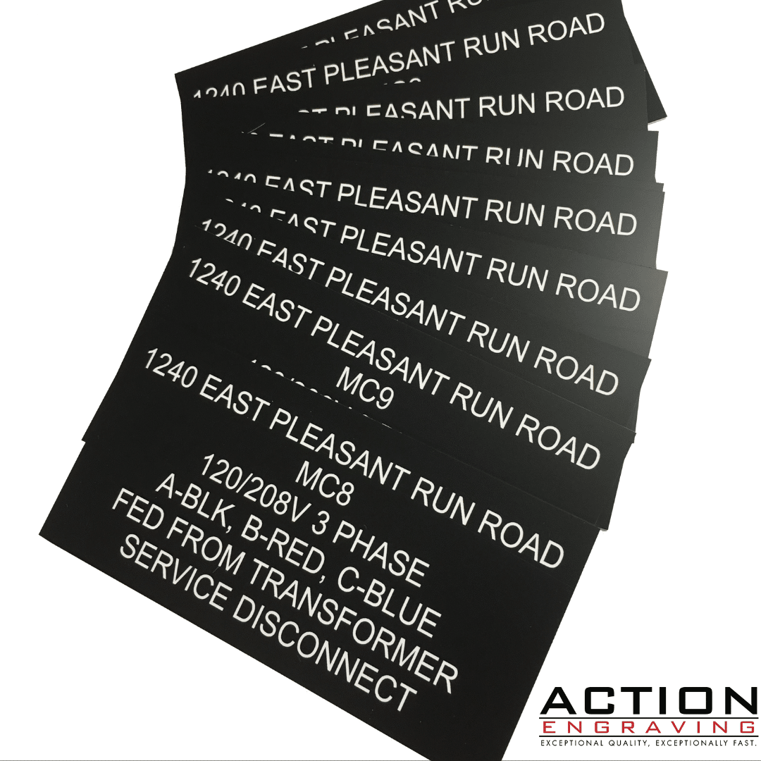 black plastic with white letters engraved signs